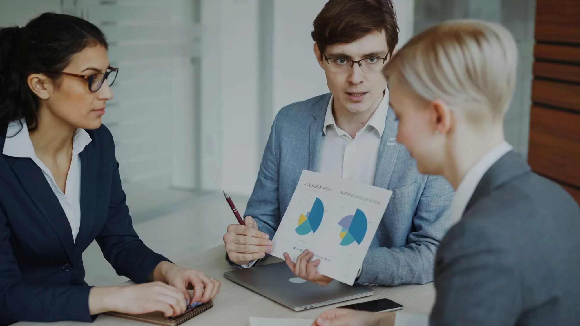 Investors reviewing financial charts in an office