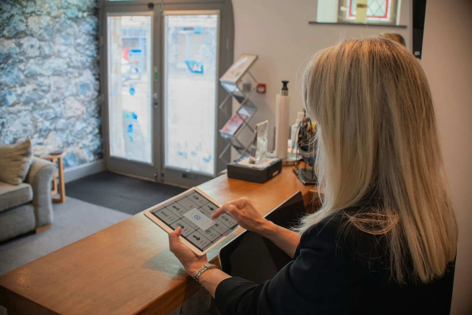 A receptionist working at a dental front desk