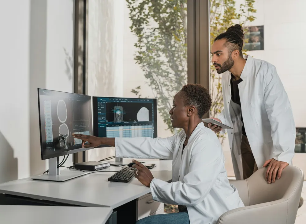 Medical professionals reviewing a scan at a clinical workstation