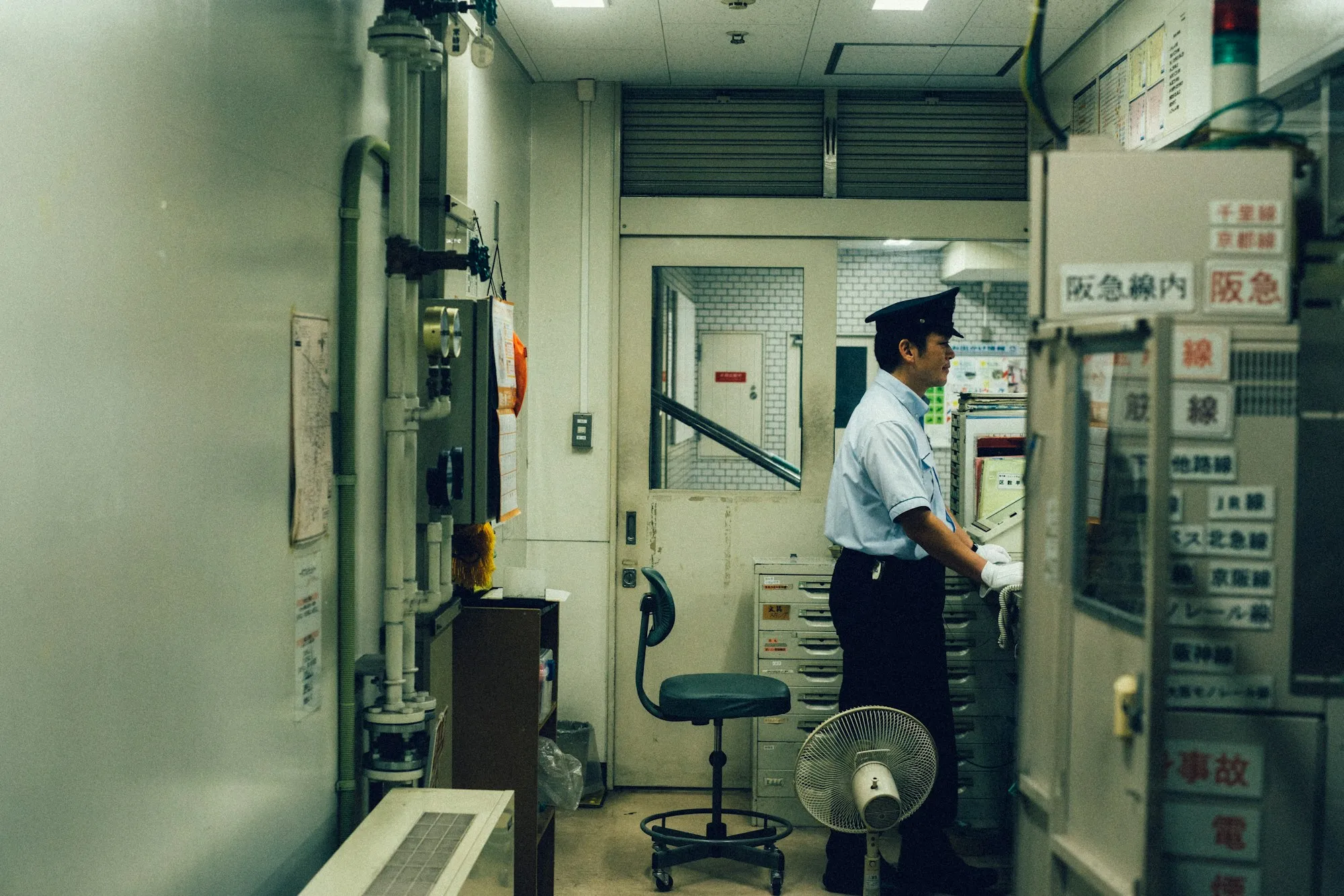 An engineer at a machine control panel on the shop floor